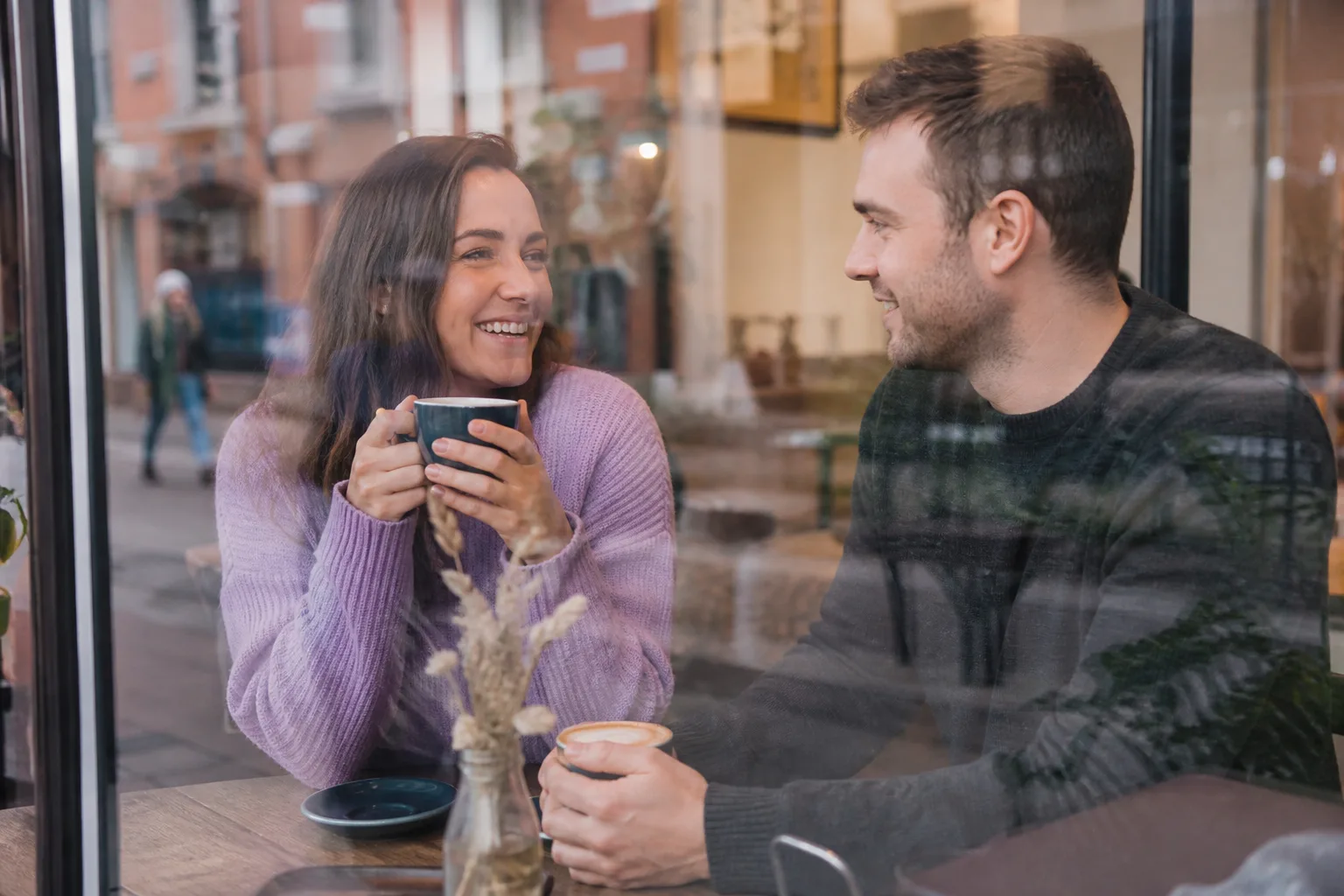 Two people talking beside the River Great Ouse in Bedford